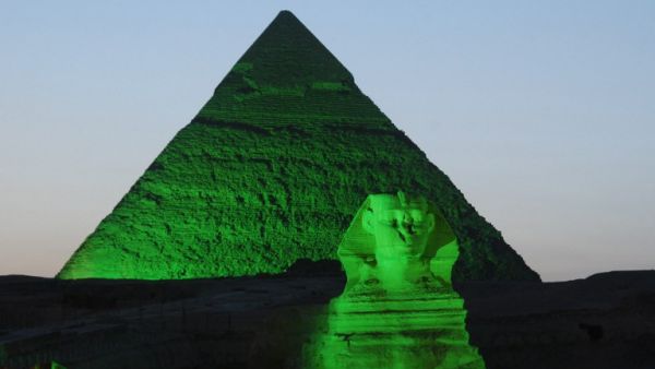 A picture shows one of the three Giza Pyramids and the Sphinx (foreground) lit in green on the occasion of St. Patrick's Day. (AFP PHOTO/IRISH EMBASSY/HO) 