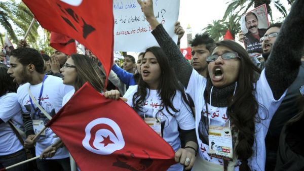 Tunisian women shout slogans during a demostration in the center of Tunis after the opening of the World Social Forum (WSF) on March 26, 2013. More than two years after the Jasmine revolution, tens of thousands of people are expected for the WSF, dubbed the forum of "dignity", a watchword of the Tunisian uprising that inspired revolts across the Arab world. (AFP PHOTO/FETHI BELAID)