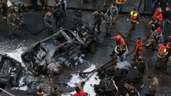 Lebanese security forces and firefighters at the scene of a huge car bomb explosion that rocked central Beirut on December 27, 2013. [AFP]