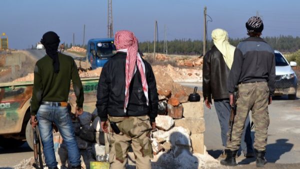 Rebel fighters man a checkpoint close to Jabal al-Zawiyaa in Idlib province on January 6, 2014. [AFP]