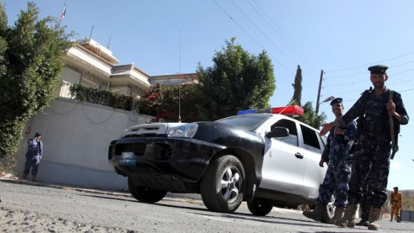 Guards on watch after an unknown assailant killed an Iranian diplomat in a drive-by shooting outside the ambassador's residence in the Yemeni capital. [AFP]