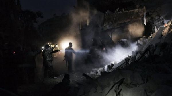 Syrians look for survivors amidst the rubble of a building targeted by a missile in the al-Mashhad neighbourhood of Aleppo. (AFP PHOTO / STR) Syrians look for survivors amidst the rubble of a building targeted by a missile in the al-Mashhad neighbourhood of Aleppo. (AFP PHOTO / STR)