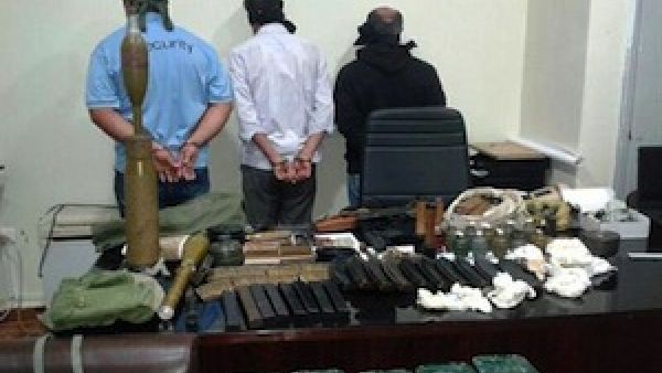 In this picture released by the State Security on Friday, Sept. 20, 2013, blindfolded suspects stand near seized weapons and explosives. (The Daily Star/NNA, HO)