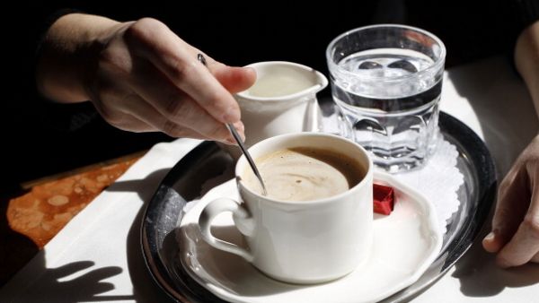 Woman presents a tray of beverages (Getty: image used for illustrative purposes)