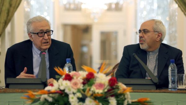 Iranian Foreign Minister Mohammad Javad Zarif  listens to International Peace envoy to Syria Lakhdar Brahimi during a joint press conference in Tehran on October 26, 2013. [AFP]