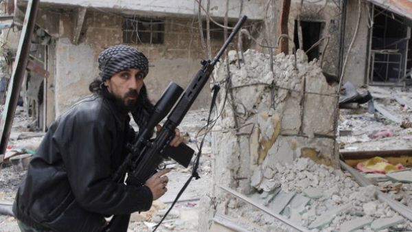 A rebel fighter from the Free Syrian Army holds a position with a Belgium made FAL rifle at a front line in the Salah al-Din neighbourhood of the northern Syrian city of Aleppo, on December 1, 2013. [Getty Images]
