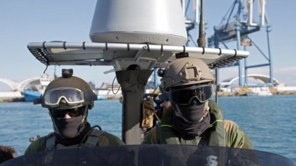 Members of the Norwegian navy special forces monitor the water around the Norwegian naval frigate 'Hnoms Helge Ingstad' off the Cypriot port city of Limassol on December 14, 2013. [Getty Images]