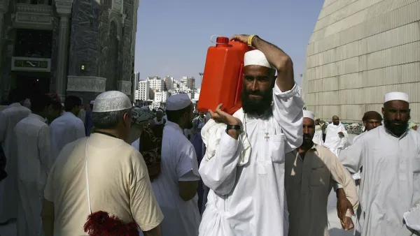 A Muslim pilgrim carries a gallon container of water from the Zamzam well the source of which comes from under the great mosque, Mecca.