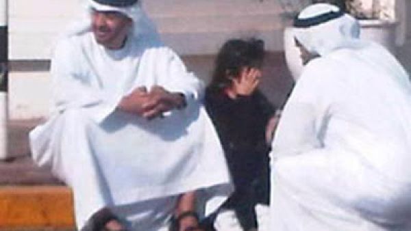 Abu Dhabi Crown Prince Sheikh Mohammed takes a break from his billions and waits with a schoolgirl.