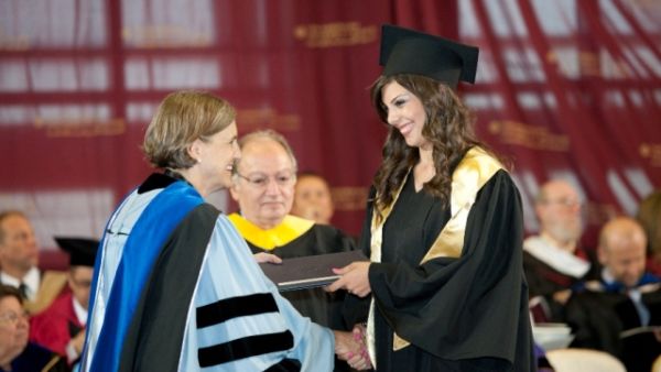 AUC undergraduate student receiving her degree from AUC President AUC undergraduate student receiving her degree from AUC President