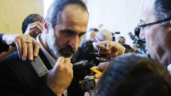 The recently resigned head of Syrian’s opposition National Coalition demanded that the leader of Hezbollah withdraw his fighters from Syria, warning of a “plot” to drag the Muslim world into long-term Sunni-Shia strife.