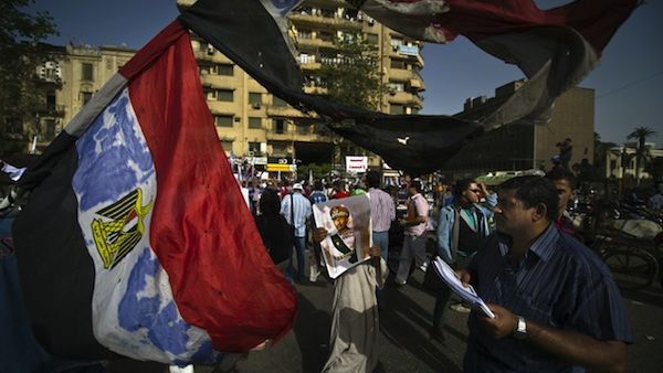 An Egyptian protester carries a picture of late president Anwar al-Sadat during a demonstration against President Mohammed Morsi on Friday in Tahrir Square, Cairo. AFP photo An Egyptian protester carries a picture of late president Anwar al-Sadat during a demonstration against President Mohammed Morsi on Friday in Tahrir Square, Cairo. AFP photo