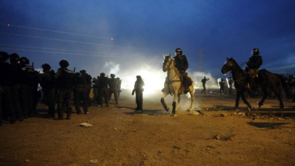 Mounted Israeli security stand guard as Bedouins protest against the Prawer plan in the southern village of Hura on November 30, 2013. (AFP)