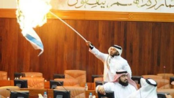 Osama Al Tamimi sets the Israeli flag on fire in Parliament.