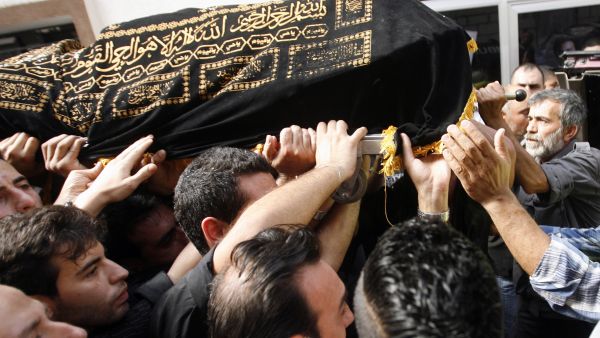 Mourners carry the body of Hassan Ramadan, who was killed in a blast in Beirut earlier in the week, during a funeral in the southern Lebanese village of Jwaya (AFP/MAHMOUD ZAYYAT) Mourners carry the body of Hassan Ramadan, who was killed in a blast in Beirut earlier in the week, during a funeral in the southern Lebanese village of Jwaya (AFP/MAHMOUD ZAYYAT)