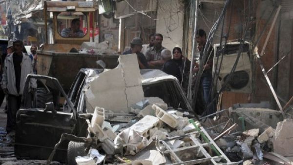 A mortar shell hit the Iraqi consulate in the Syrian capital Damascus Thursday, killing an Iraqi woman. The capital has been targeted by bombs and mortar shells in recent months. Here, Syrians inspect the sight of a car bomb attack in Damascus' Tadamun neighbourhood last week. (AFP)