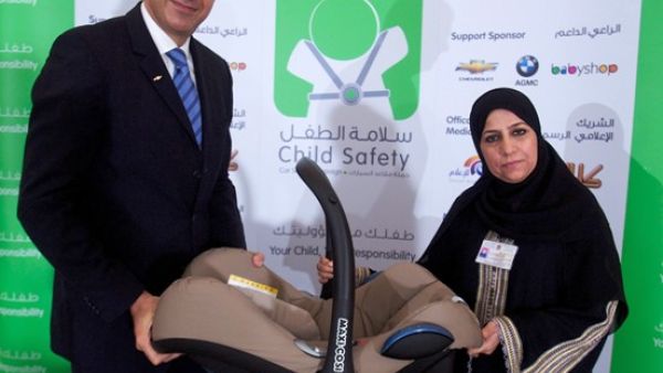 Luay Al Shurafa, Regional Brand Manager of Chevrolet handing over a child seat to Sara Timore, a representative from Al Qassimi Hospital