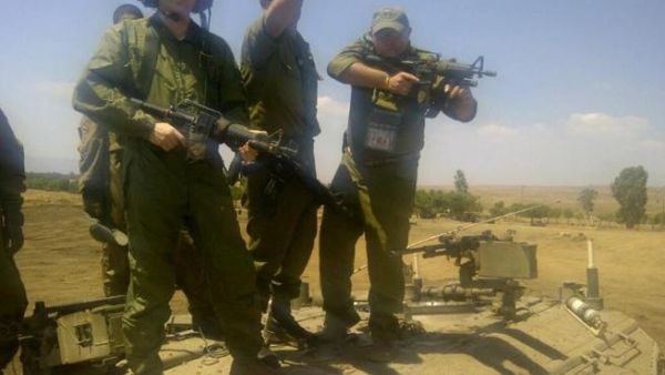David Storobin poses with machine gun in hand