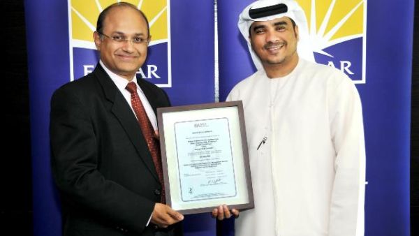 Ahmad Al Falasi, Executive Director and Jeevan J D’Mello, Senior Director of Emaar Community Management receiving the certification from Lloyds Register Quality Assurance