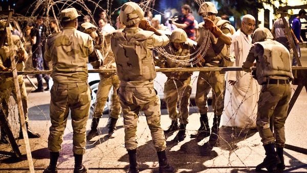 Egyptian army soldiers take out barbed wire that was surrounding the Supreme Constitutional Court in Cairo ahead of planned demonstrations on August 18, 2013. (AFP) Egyptian army soldiers take out barbed wire that was surrounding the Supreme Constitutional Court in Cairo ahead of planned demonstrations on August 18, 2013. (AFP)