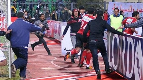 Ahli players being rushed to safety.