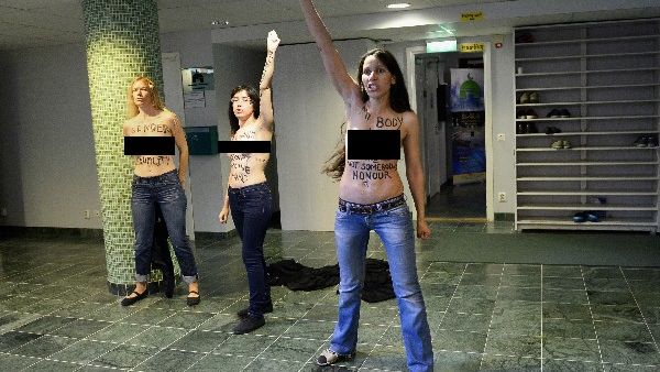 Egyptian activist Aliaa Elmahdy (C) and other members of feminist group FEMEN stage a topless protest  inside a Mosque in Stockholm, Sweden on Saturday (AFP)