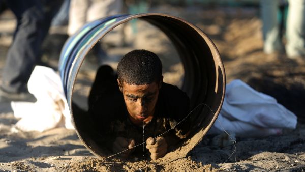 A Palestinian youth crawls through a tunnel during a summer physical training camp run by Hamas in Gaza City on June 21, 2013. (Source: AFP/MOHAMMED ABED)