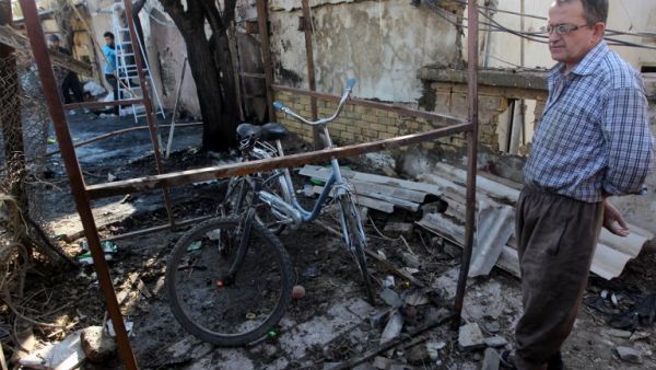 An Iraqi man inspects the site of a car bomb explosion in the Taubchi neighbourhood of the capital Baghdad on January 19, 2014, a day after the attack. (AFP)