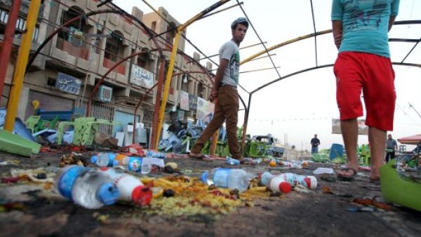 Iraq has been plagued by sectarian violence in 2013, with over 1,000 people dying in July alone. Here, Iraqis inspect the site the day after a bombing attack near a funeral tent that killed at least 56 in the Sadr City district of Baghdad on September 22, 2103. (AFP)