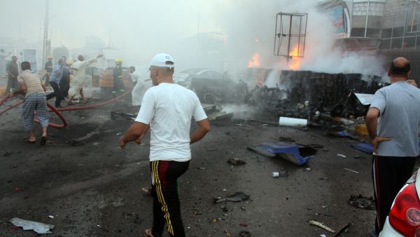 Iraqis rush to the scene of an explosion in the city of Nasiriyah, south of the Iraqi capital Baghdad, on July 15, 2013. (AFP)