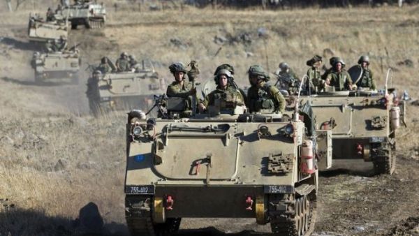 Israeli army Armored Personnel Carriers maneuver during a military exercise near the northern border with Syria on June 25, 2013. (AFP/File)