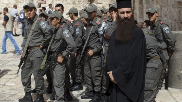Israeli border police gather in the area of the Church of the Holy Sepulchre in Jerusalem's Old City on October 6, 2013, as Palestinian Christians rally during a demonstration against acts of vandalism on Christian sites in Jerusalem. (AFP)