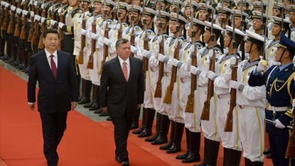 Jordan's King Abdullah II (C) and China's President Xi Jinping (L) review an honour guard during a welcoming ceremony at the Great Hall of the People in Beijing on Wednesday. (AFP)
