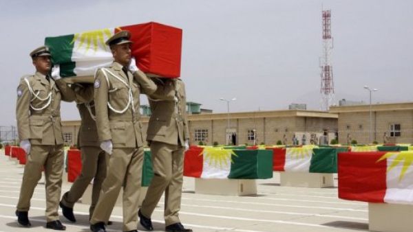 Iraqi Kurdish police officers carry a coffin draped with the Kurdish flag, on May 28, 2012 (AFP/File)