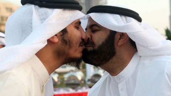Former Kuwaiti MPs Mubarak al-Walan and Bader al-Dahoum give each other a nose kiss during a gathering in Eid al-Adha. (AFP)