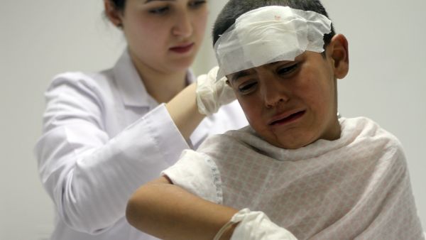 A nurse attends to a wounded boy in the eastern Lebanese city of Baalbek, near the Syrian border. Later reports suggested the boys injuries may have been caused by a Syrian airstrike by the Lebanese border (AFP/STR)
