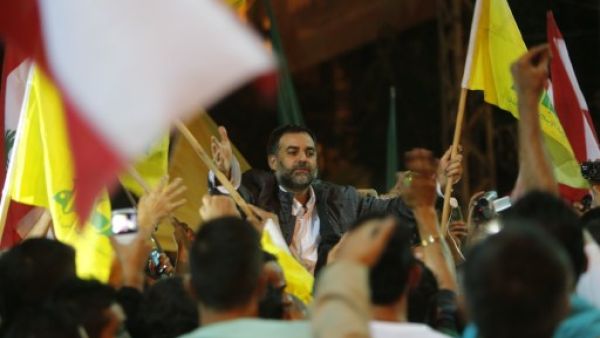 One of the nine Lebanese Shiite pilgrims abducted by rebels in Syria is greeted upon arrival in Bir al-Abed in the southern suburbs of Beirut on October 19, 2013, after being released in Turkey the previous day. (AFP)