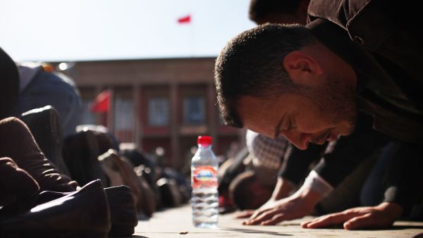 Praying at Parliament: Moroccans pray outside parliament as thousands protest against King Mohammed VI, February, 2011. 