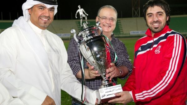 CEO of Gulf Bank and KBC Cup Chairman handing the victory trophy to the Gulf Bank team