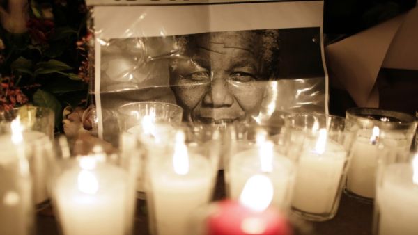 The UAE will host a heartfelt memorial to the late and great Nelson Mandela on Wednesday. Flowers are layed on December 6, 2013, on the ground in front of the South African Embassy in Paris. (AFP)