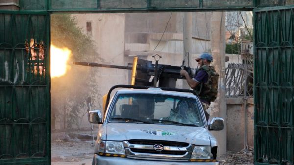 A Syrian rebel fighter fires from a truck during clashes with forces loyal to the regime in the eastern Syrian town of Deir Ezzor on August 1, 2013. (AFP)