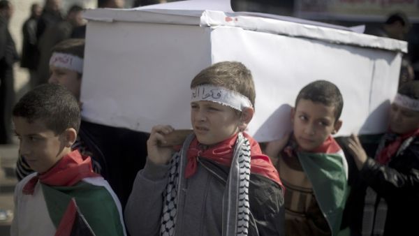 Palestinian children carry a fake coffin as they take part in a sit-in on January 4, 2014 in Gaza city in solidarity with Palestinian children at Yarmouk refugee camp in Syria. (AFP)