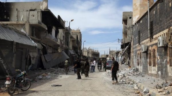Syrian army soldiers assess a damaged street in the town of Qusair, in Syria's central Homs province on  Friday, as the regime sought to 'remove' all remaining rebel strongholds in the country. AFP  Syrian army soldiers assess a damaged street in the town of Qusair, in Syria's central Homs province on  Friday, as the regime sought to 'remove' all remaining rebel strongholds in the country. AFP