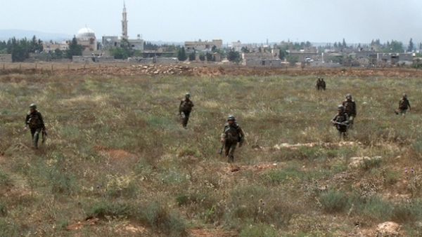  Syrian army soldiers walking nearby facilities of Dabaa military airfield during an operation that led to the control of the airport, north of the Syrian city of Qusayr. AFP Photo