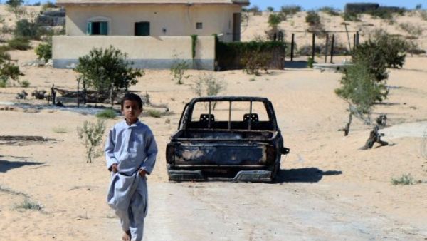 An Egyptian child walks in front of the wreckage of a burnt down car, the day after an attack by Egyptian Army in a village on the outskirt of the Northern Sinai (AFP)
An Egyptian child walks in front of the wreckage of a burnt down car, the day after an attack by Egyptian Army in a village on the outskirt of the Northern Sinai (AFP)