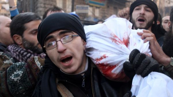 Mourners carry the body of a comrade killed during battles with members of the al-Qaeda-linked group Islamic State of Iraq and the Levant (ISIL), in the northern city of Aleppo, on January 8, 2014.