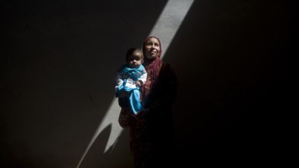 Amina, a Syrian woman who fled the fighting in Aleppo, is photographed inside an abandoned building with her five-month-old sick daughter, Asma, on the outskirts of Saraqib, southwest of Aleppo, on September 9, 2013. According to the Red Cross, more than one million Syrians are going hungry. (AFP)
