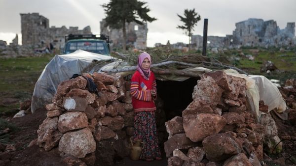 A Syrian girl stands at the entrance of a makeshift home set up in the catacombs of the ruins of a building in the ancient Roman city of of Serjilla, in northwestern Syria, on Monday. (AFP Photo/Daniel Leal-Olivas)
