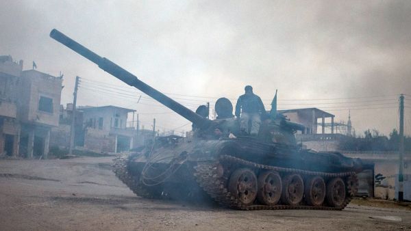 Syrian rebels drive a T-72 tank, captured from government forces two months ago, in the village of Kfarruma in the flashpoint Syrian province of Idlib near the border with Turkey, on Monday (AFP Photo/Daniel Leal-Olivas)