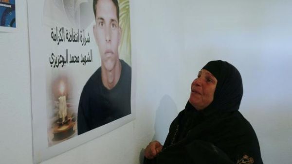 Mohamed Bouazizi's mother, Mannoubia Bouazizi, looks on to his memory. (Image courtesy of "ibtimes.com")